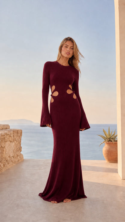 Model wearing a deep burgundy ribbed knit cutout bell sleeve maxi dress