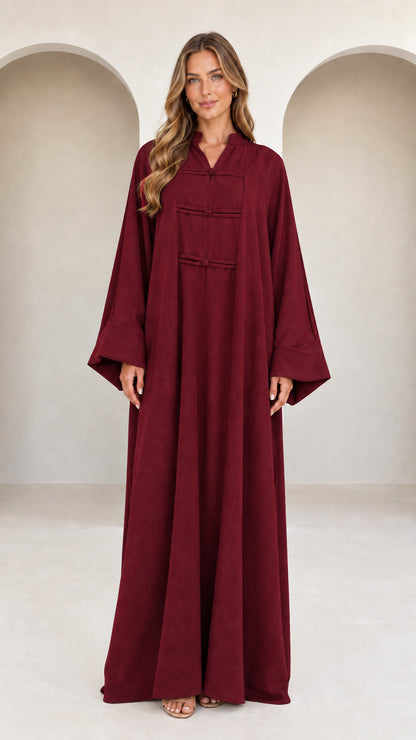 Front view of model wearing burgundy wine red long sleeve frog button maxi dress