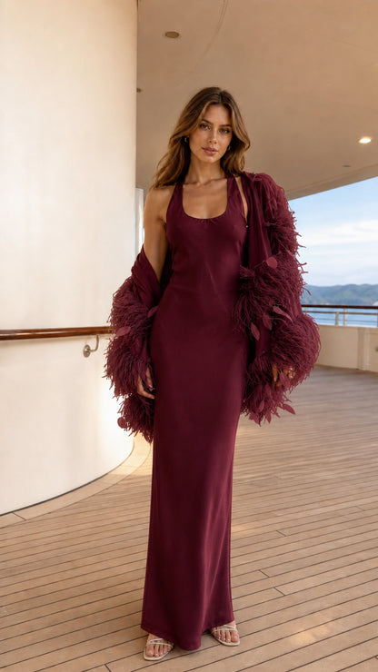 Model wearing burgundy satin maxi dress and burgundy feather shrug