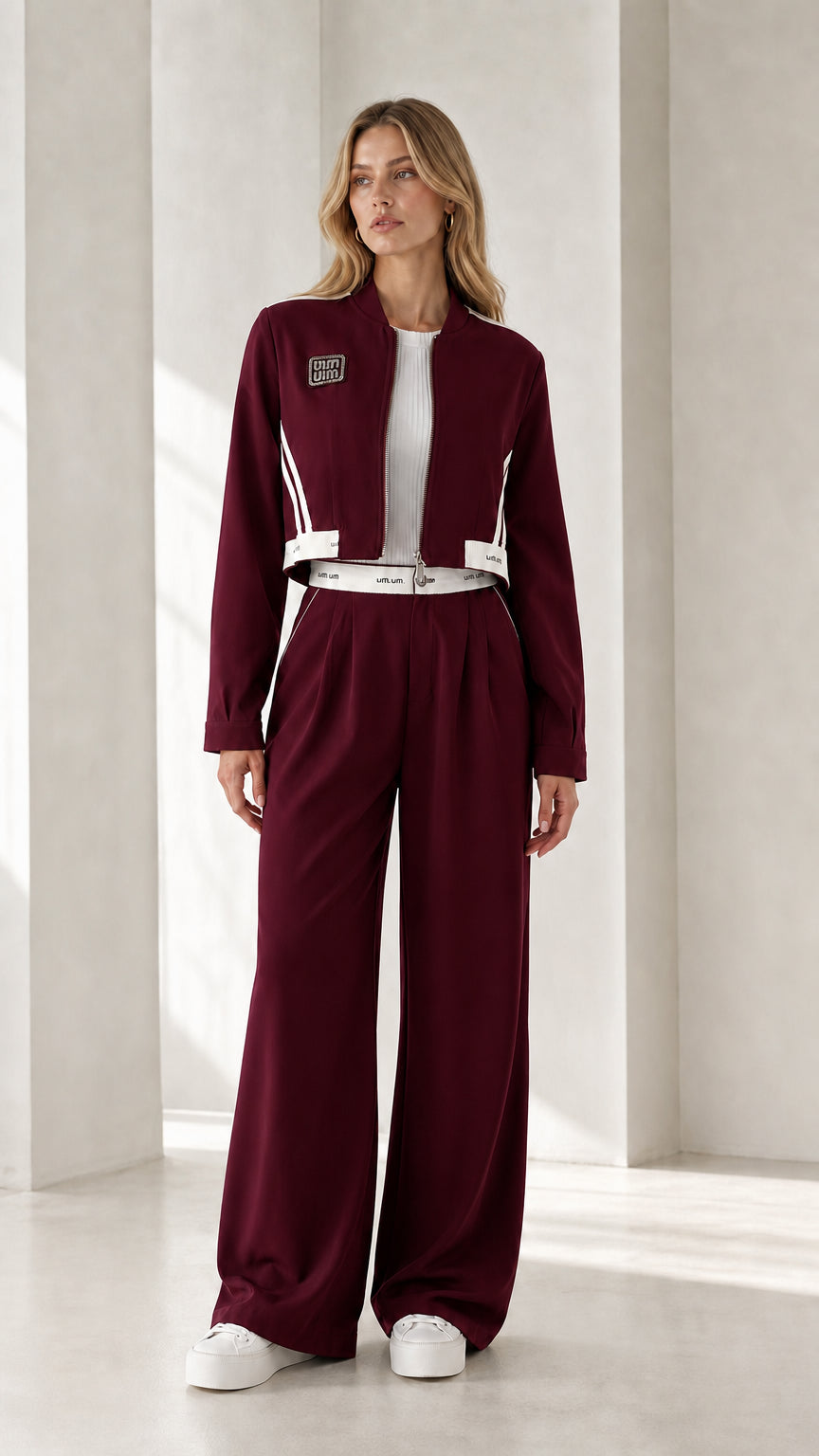 Full view of model wearing burgundy cropped jacket and wide-leg pants set