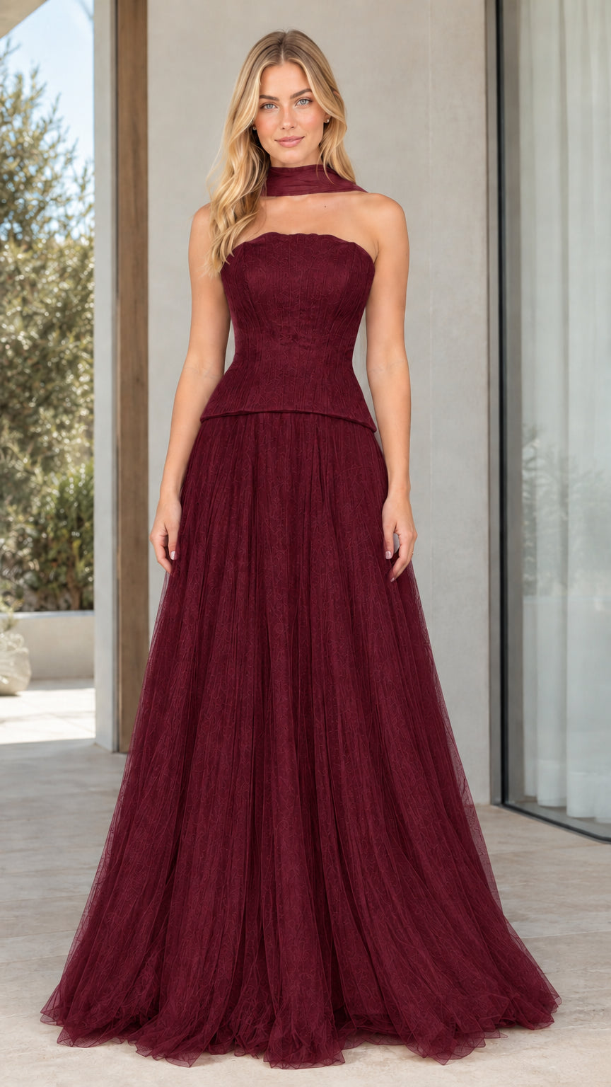 Model wearing rich burgundy strapless peplum corset tulle evening dress