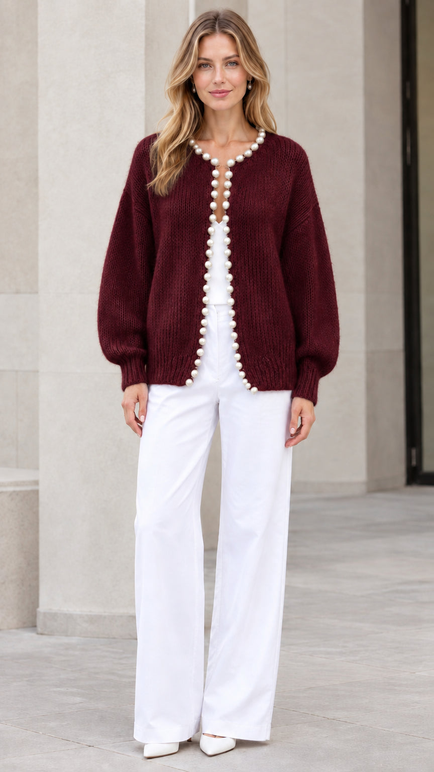 Model wearing Burgundy pearl-trimmed knit cardigan sweater with white trousers