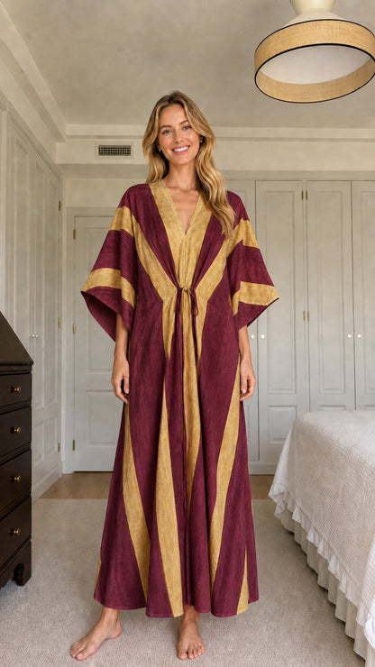 Model wearing burgundy and gold striped maxi kaftan dress