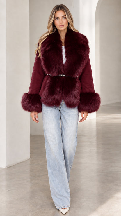 Model wearing burgundy wine red belted jacket with plush faux fur trim