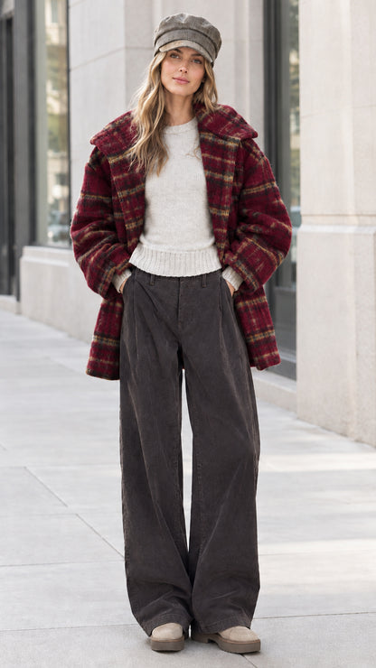 Front view of model wearing burgundy red plaid lapel coat