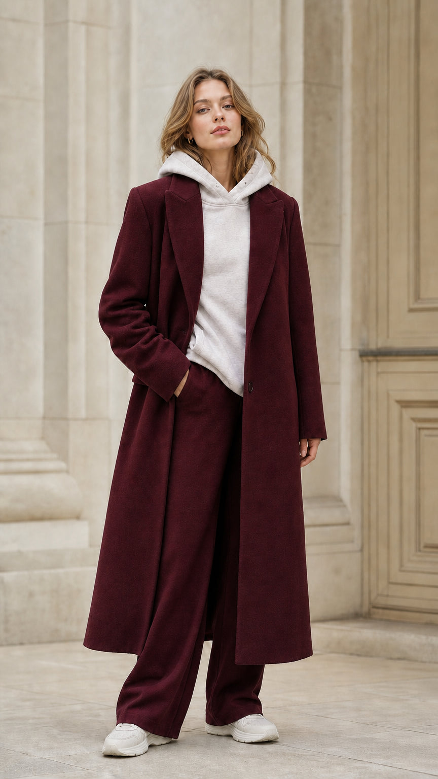 Front view of model wearing burgundy longline tailored wool look coat