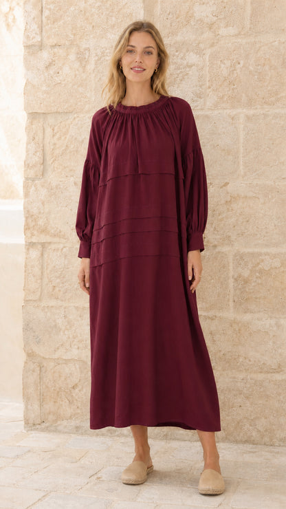 Full front view of model wearing burgundy tiered maxi dress