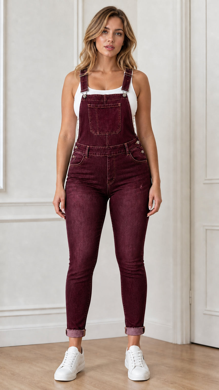 Front view of woman wearing burgundy denim overalls