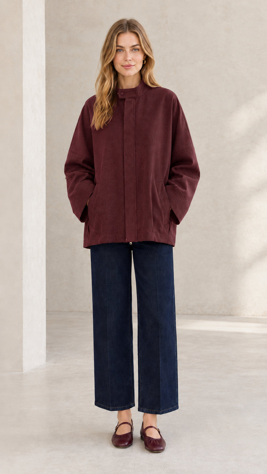Front view of woman wearing deep burgundy stand collar everyday outerwear jacket