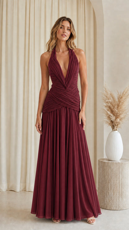 Front view of burgundy halter plunging ruched waist pleated formal dress