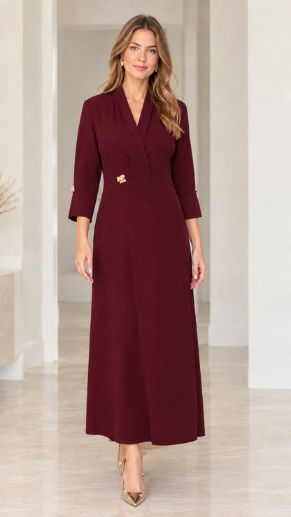 Front full-length view of woman in rich burgundy lapel V-neck maxi dress