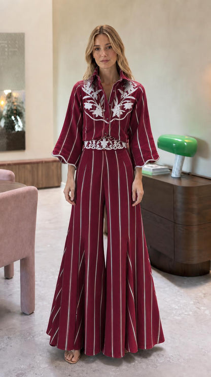 Front view of burgundy striped embroidered wide leg jumpsuit