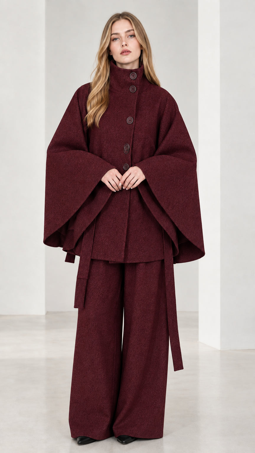 Front view of burgundy wine high neck belted cape coat and wide-leg trousers set
