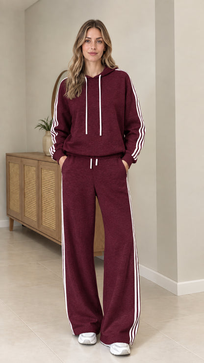 Model wearing Burgundy two-piece tracksuit set with white side stripes