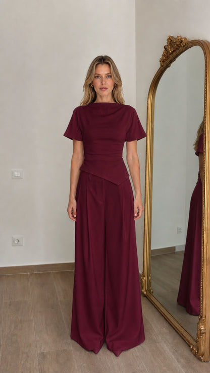 Front view of woman wearing burgundy matching top and wide-leg pants