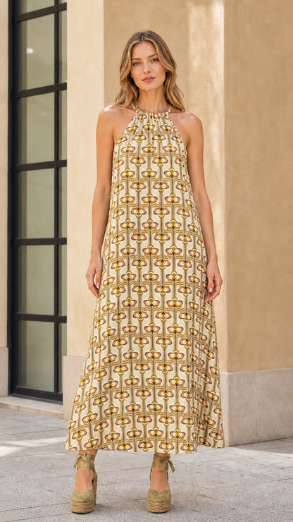 Model wearing beige geo print halter maxi dress