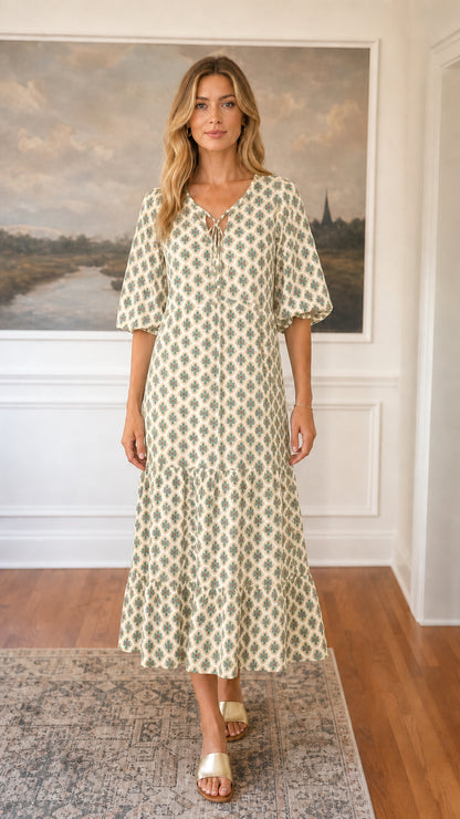 Front view of beige floral tiered midi dress