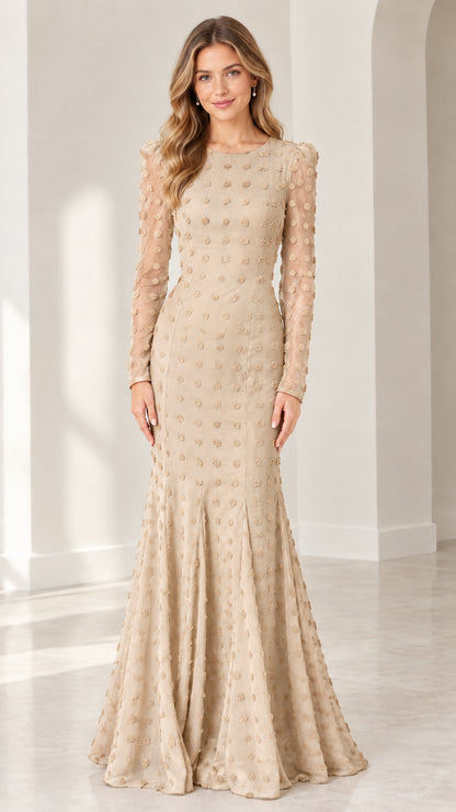 Full front view of model wearing champagne beige long sleeve swiss dot mermaid evening gown