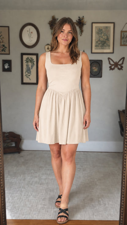Front view of woman wearing beige mini dress