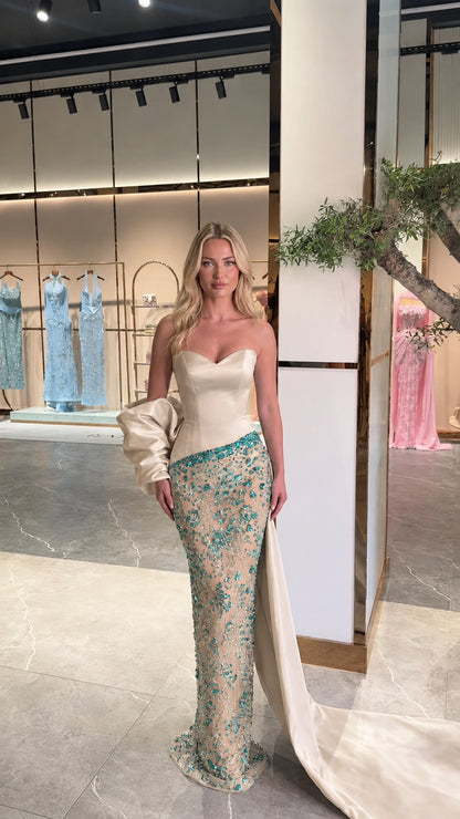 Model wearing champagne ivory strapless crystal embellished formal dress with train