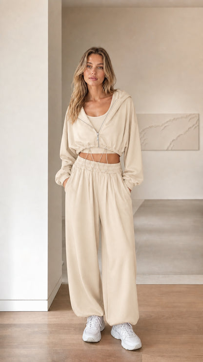 Front view of woman wearing beige cream 3-piece cropped hoodie and sweatpants set