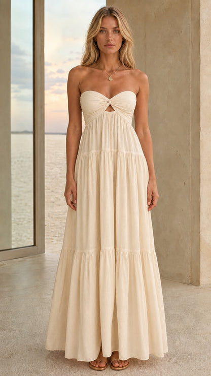 Front view of an ivory strapless tiered maxi dress