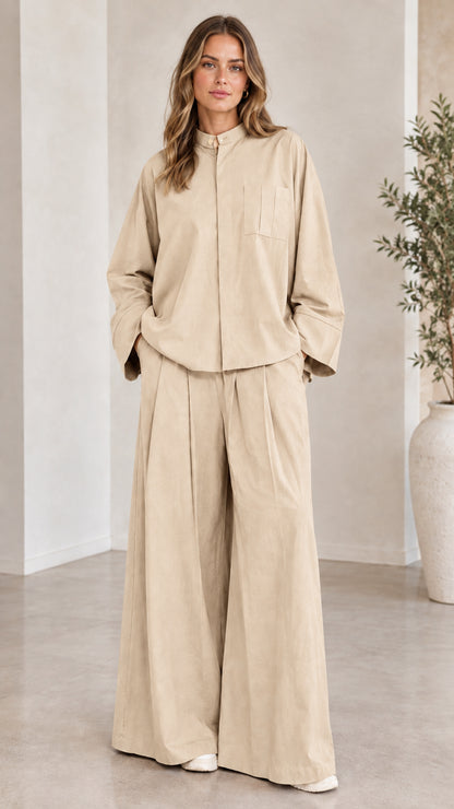 Front view of woman wearing the matching two-piece wide-leg set in beige