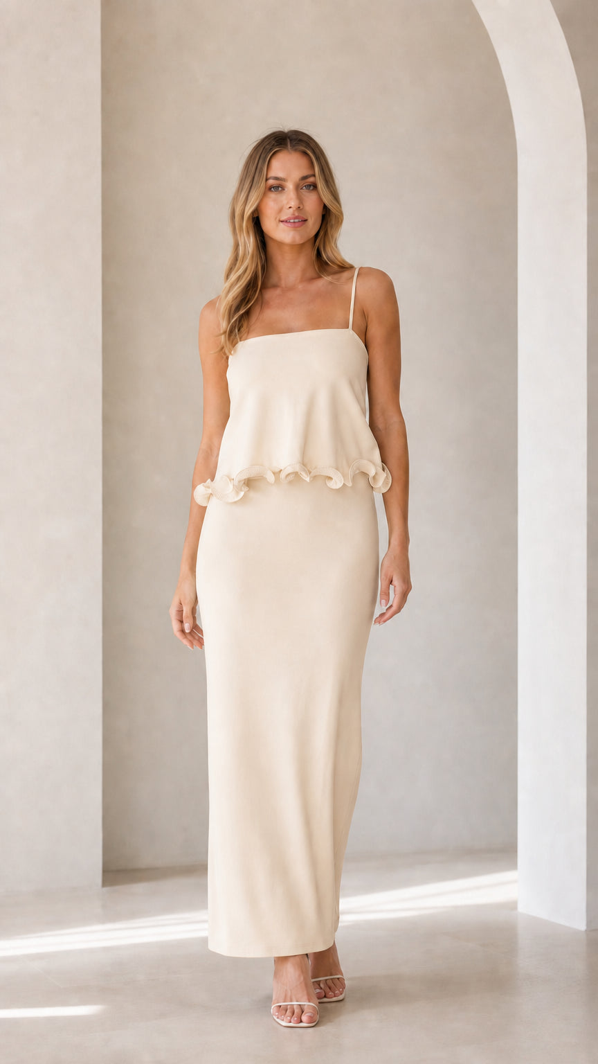 Model wearing cream sleeveless ruffle trim maxi camisole dress