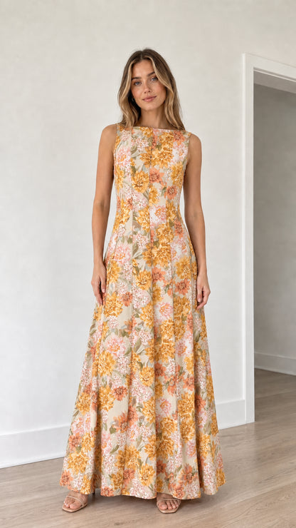 Woman wearing yellow floral print maxi dress