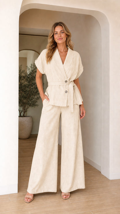 Model wearing cream two-piece blazer and wide leg pants set
