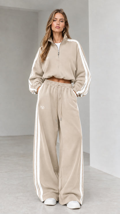 Front view of woman wearing beige cropped quarter-zip tracksuit set