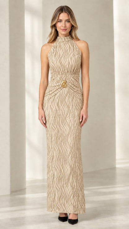 Front view of woman wearing champagne gold textured halter column dress