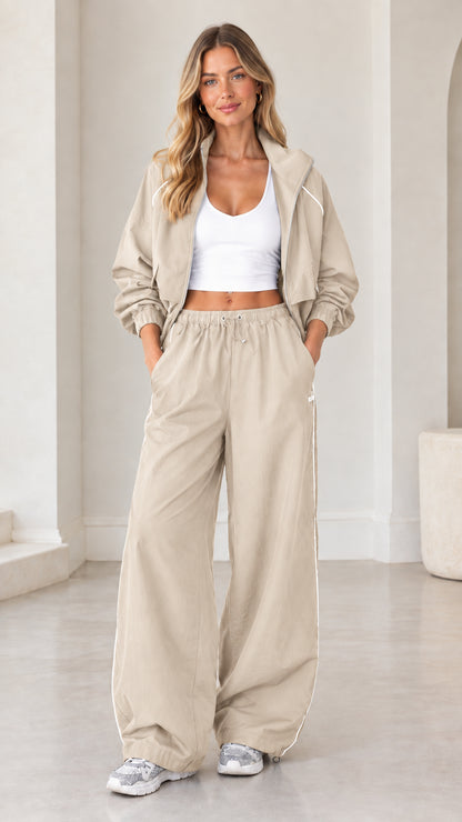 Model wearing beige neutral cropped zip-up tracksuit two-piece set