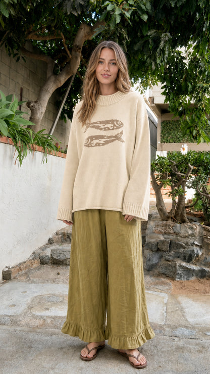 Front view of model wearing Cream beige fish motif oversized knit sweater