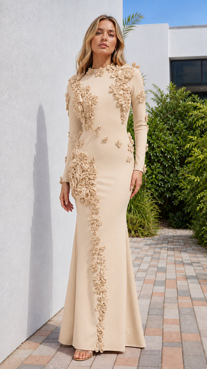 Front view of model wearing champagne long sleeve evening gown