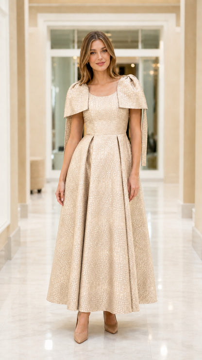 Full-length view of model wearing Champagne gold capelet jacquard maxi evening dress