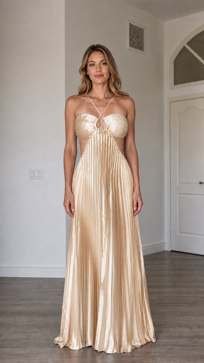 Front view of model wearing the champagne metallic pleated halter maxi dress
