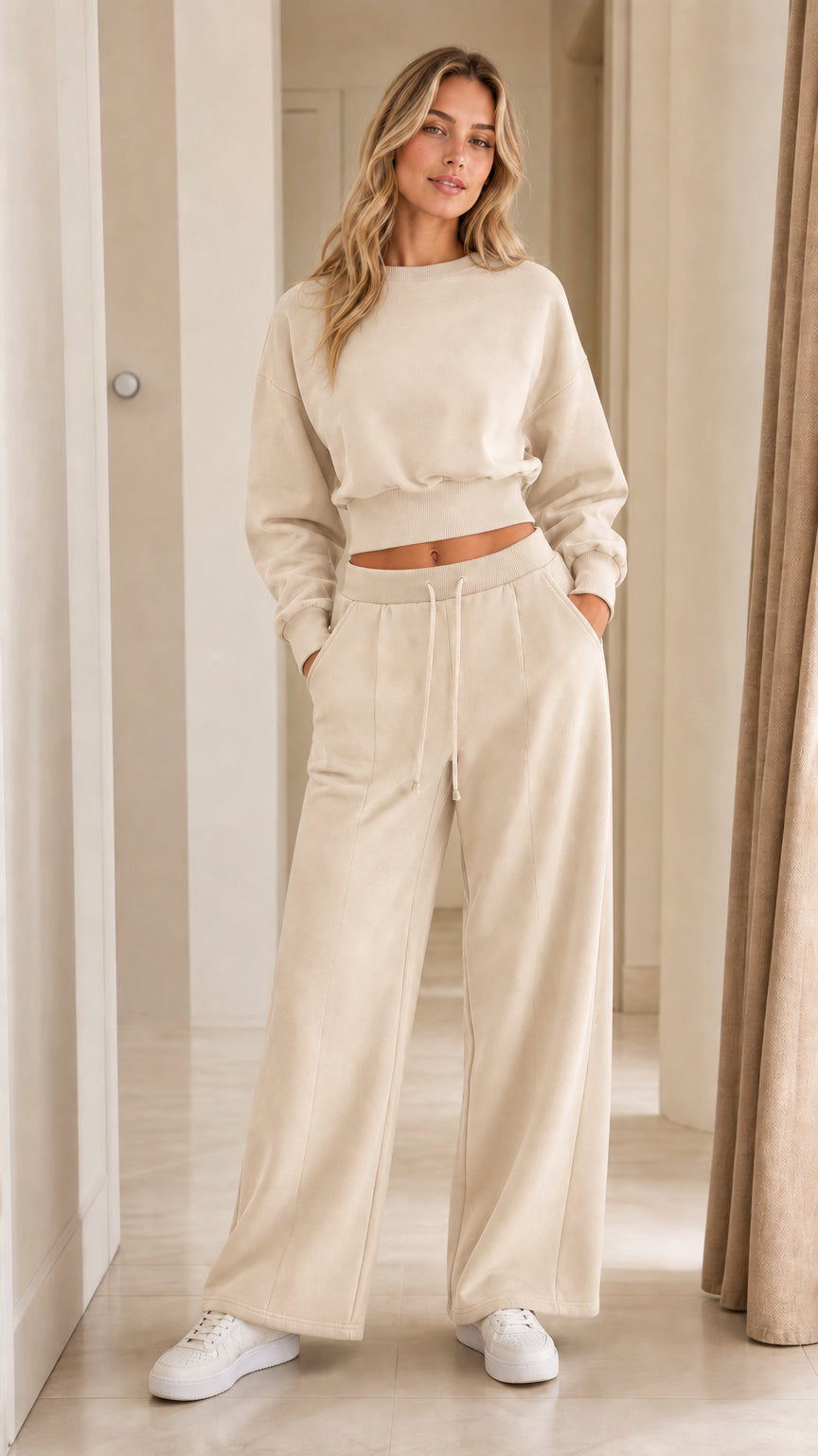 Woman posing in cream off-white two-piece cropped sweatshirt and wide-leg sweatpants