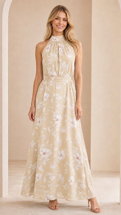 Front view of woman wearing champagne cream floral halter neck maxi dress