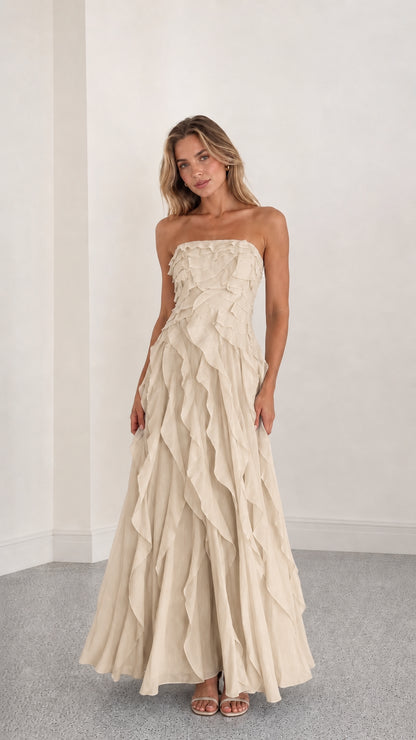 Full length view of beige strapless ruffle maxi dress