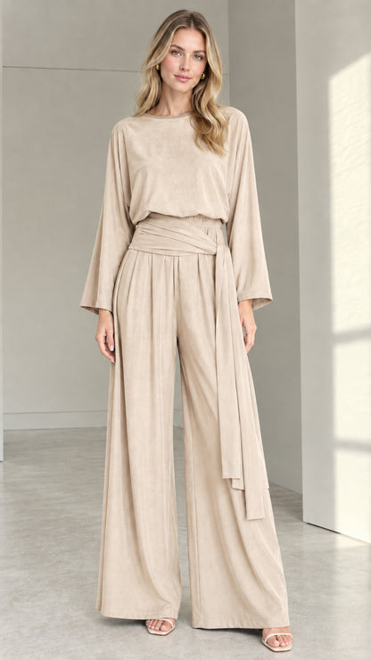 Front full view of woman wearing beige oatmeal long-sleeve wide-leg jumpsuit