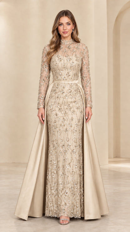 Front view of model in Champagne gold sequined lace evening gown with overskirt