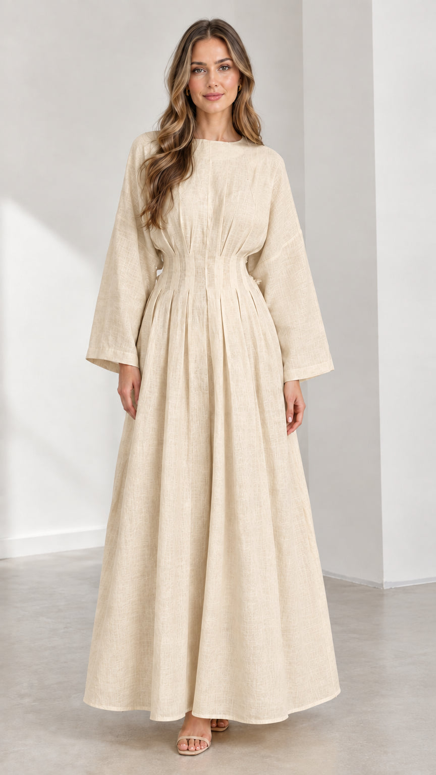Front view of woman wearing Beige neutral pleated waist long sleeve maxi dress