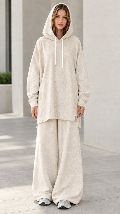 Woman wearing oatmeal beige longline tunic hoodie and wide-leg matching sweatsuit set