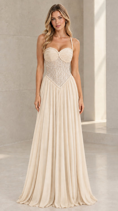 Front view of model wearing Champagne ivory beaded corset pleated maxi dress