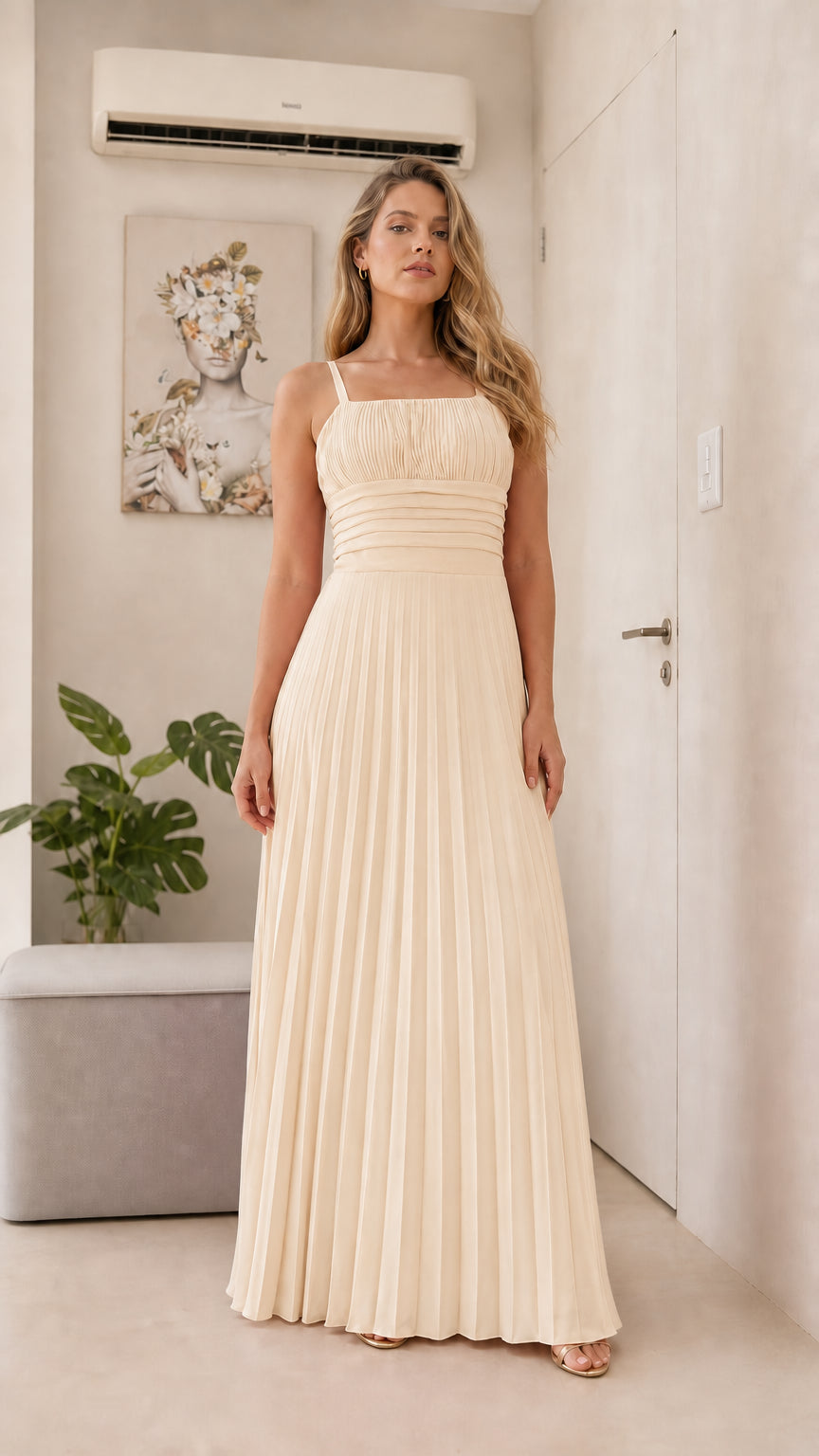 Front view of model wearing the champagne pleated maxi dress