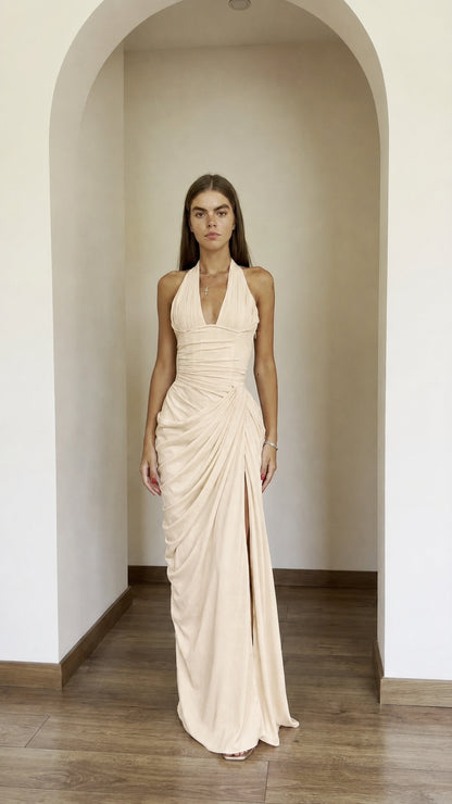 Front view of model wearing champagne halter ruched maxi dress