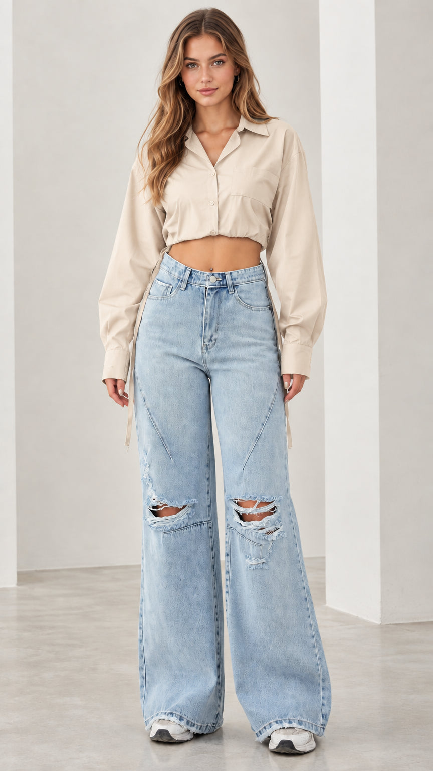 Front view of woman wearing beige cream cropped long sleeve shirt