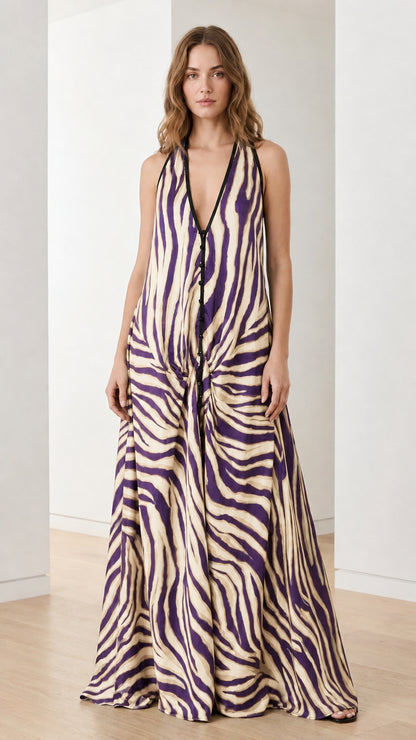 Woman wearing cream and purple zebra print halter maxi dress