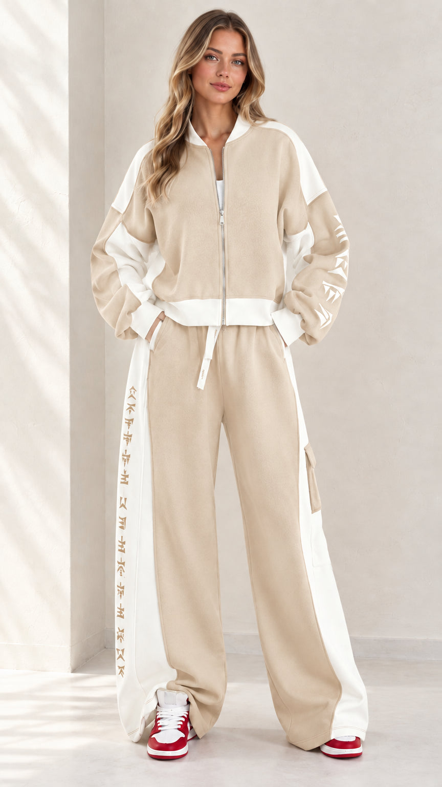 Full front view of model wearing beige khaki and white colorblock zip-up tracksuit set